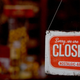 A closed sign hangs on a restaurant door.